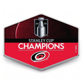 Hexagonal badge with Stanley Cup Champions text and Carolina Hurricanes logo on a white background
