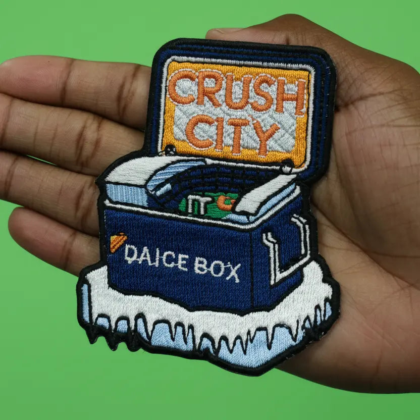 Patch with 'Push City' and 'Daice Box' text held in a hand against a green background