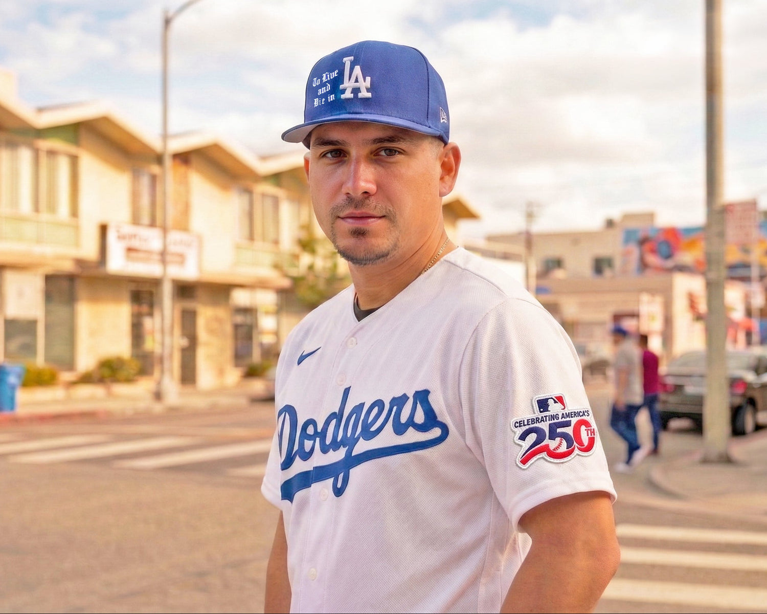 Person wearing a Dodgers jersey and cap standing on a street with buildings and people in the background