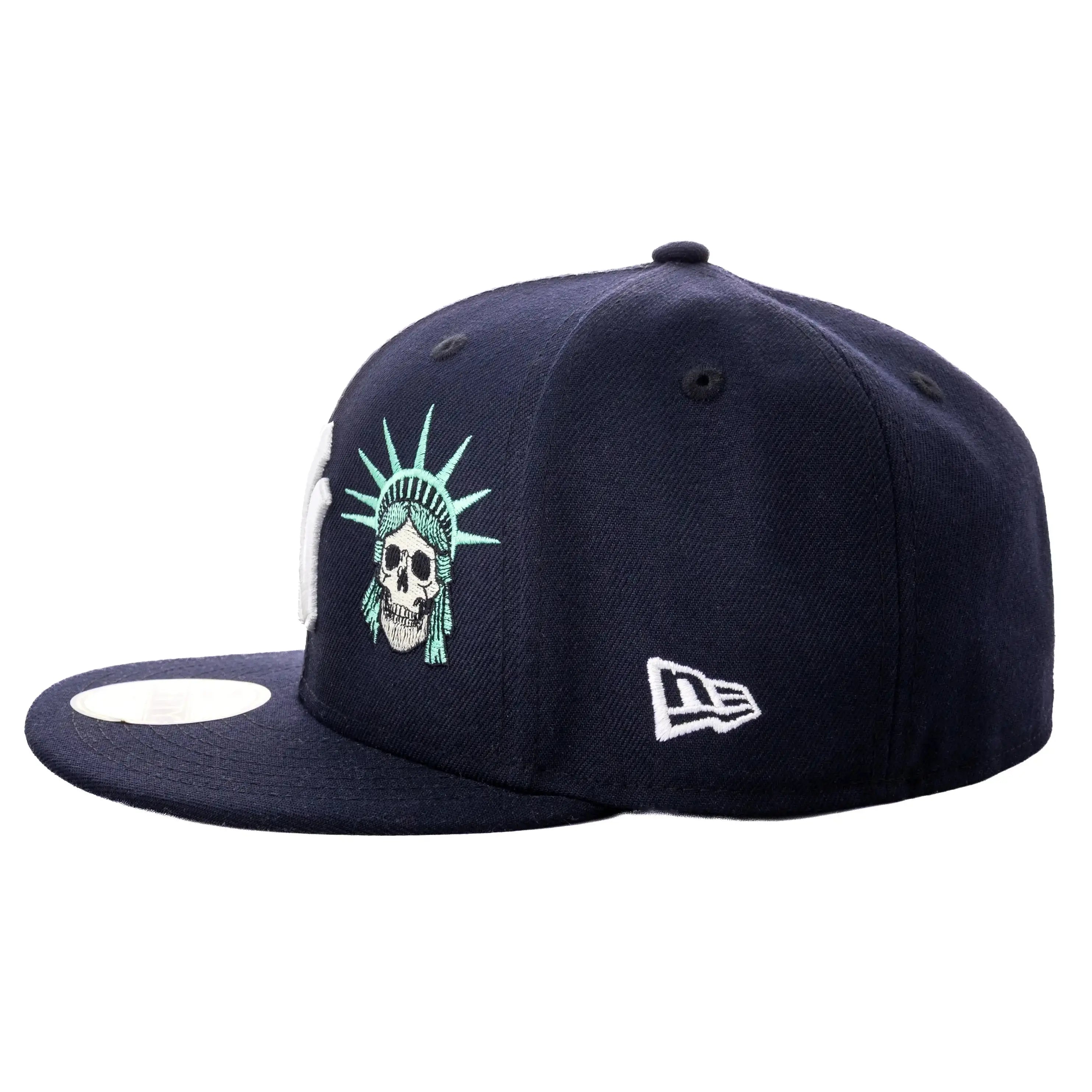 Navy blue cap with skull and liberty statue design on a white background