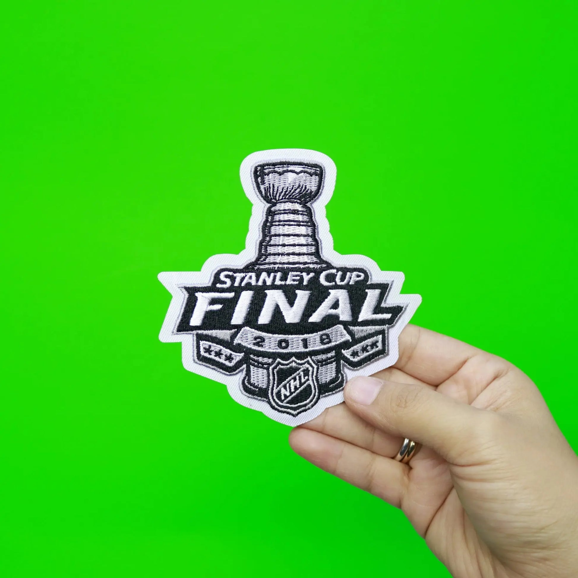 https://patchcollection.com/cdn/shop/products/2018-STANLEY-CUP-FINAL-PATCH-WITH-HAND.jpg?v=1686489926&width=1946
